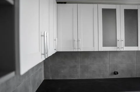 Custom kitchen cabinets installation with a white furniture facades mdf. Gray Stock Photos