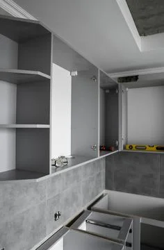 Custom kitchen cabinets installation without a furniture facades mdf. Gray Stock Photos