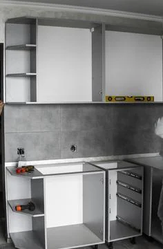 Custom kitchen cabinets installation without a furniture facades mdf. Gray Stock Photos