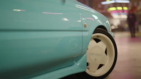 Custom modified light blue car wheel detail in a garage Stock Footage 329278747
