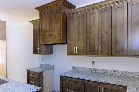 Custom modular kitchen cabinets installed in a new house under construction Stock Photos