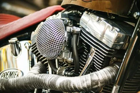 Custom motorcycle engine showcasing chrome air filter and exhaust wrap Stock Photos