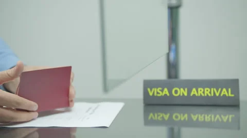 Custom officer checking and putting visa stamp in passport at the airport Stock Footage 247711258