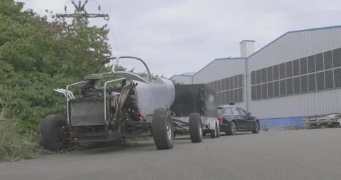 Custom Open Wheel Race Car on an Industrial Yard, Side Profile, Wide Shot Stock Footage 340310232