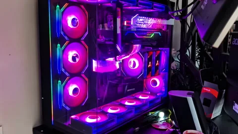 Custom PC build with vibrant, colorful LED lights illuminating the components Stock Footage 310341483