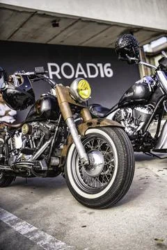 Custom vintage motorcycle with rusty elements and whitewall tire Stock Photos