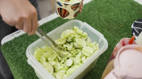 Customer Adding Cucumber to Tempura Snack - Cebu, Philippines - May 31, 2026 Stock Footage 336067582