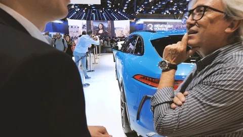 Customer and car manager talking about the new Jaguar F-Pace Stock Footage 113878299