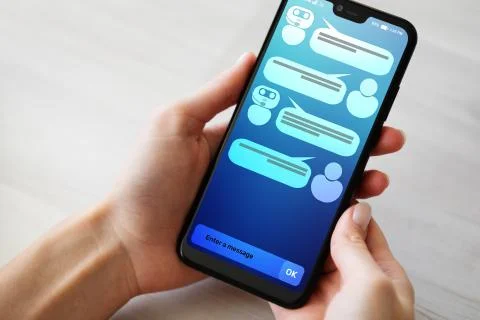 Customer and chatbot dialog on smartphone screen. AI. Artificial intelligence Stock Photos