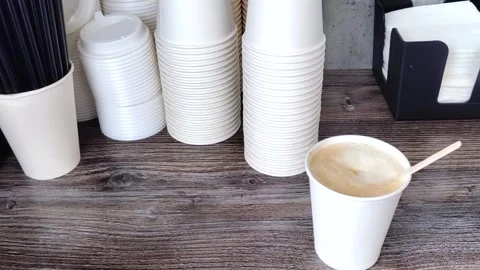 A customer area where there are plastic lids, cups, drinking straws. Stock Footage 278080614