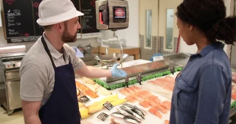 Customer asking fishmonger for advice Stock Footage 73553835