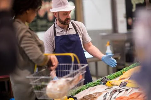 Customer asking fishmonger for advice Stock Photos