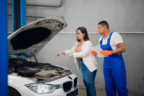 Customer asks mechanic to fix car engine Stock Photos