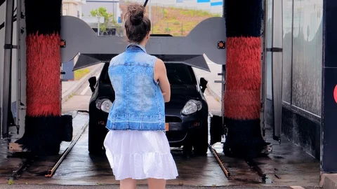 Customer Automatic car wash, waiting until the car wash Stock Footage 128492375