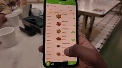 Customer Browsing Food Ordering App Menu on Smartphone at Restaurant Table 動画素材 336171452