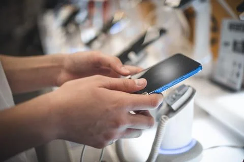 Customer Browsing New Smartphone In Electronic Store Stock Photos