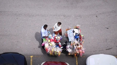 A customer is buying bread from a motorcycle baker Stock Footage 129647919