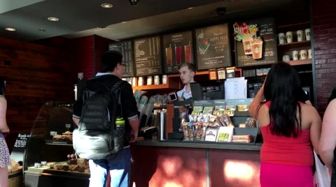 Customer buying coffee at Starbucks Stock Footage 63105867