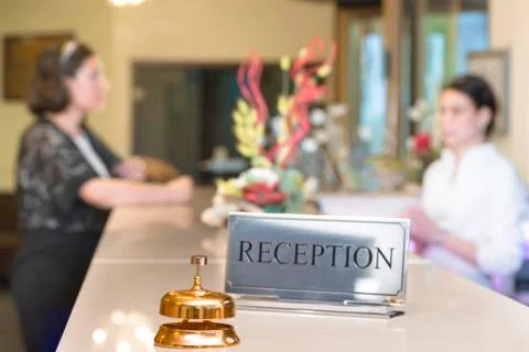 Customer at check-in talking to receptionist Stock Photos