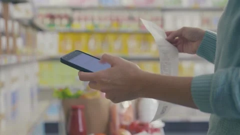 Customer checking her shopping receipt at the store Stock Footage 297850632