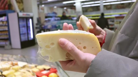 Customer chooses the cheese in the store Video stock 231248809