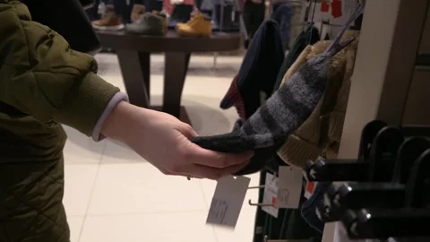 A customer chooses a hat in a store. Hand touches a hat Stock Footage 267592759