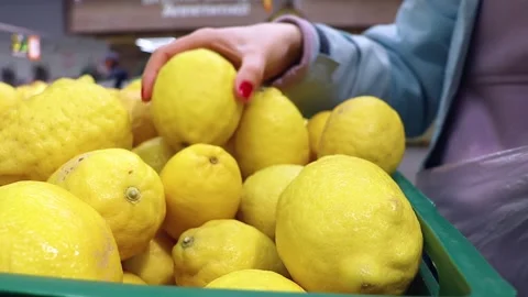 The customer chooses lemons in the store. Stock Footage 240748955