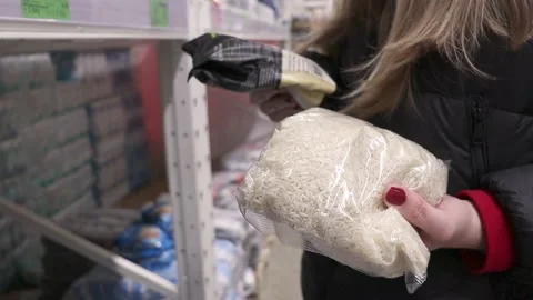 The customer chooses rice in the store Stock Footage 237115518