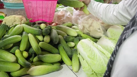Customer Choosing Fresh Cucumbers at Traditional Market Stock-Footage 340184389