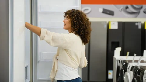 Customer choosing refrigerator in electronics store Video stock 317725897