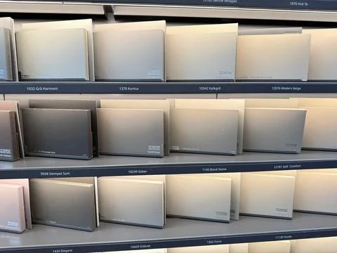 Customer comparing paint colors inside hardware store. Stock Photos