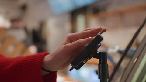 Customer completes transaction using modern point of sale system. Quick and Stock Footage 346217985