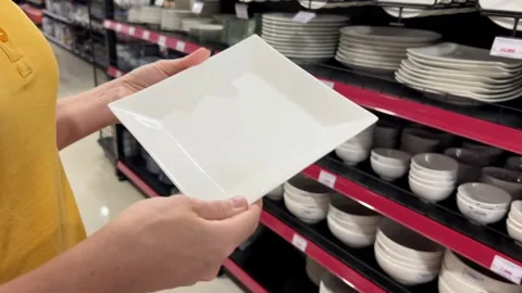 Customer Contemplates White Plate Selection Stock Footage 259499097