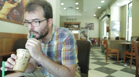 Customer drinking coffee in a coffee shop Stock Footage 50009359