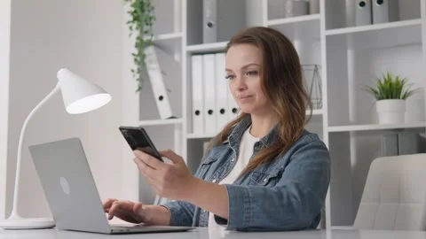 A customer of an e-store, shopping from her home, uses online banking for Stock Footage 275187390