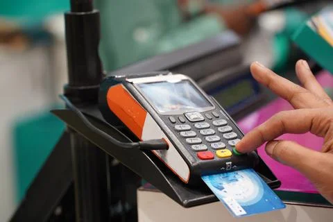 A customer entering security code on credit card reader machine, shopping, cr Stock Photos