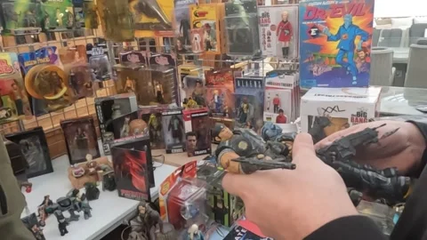 Customer Examining Gears of War Figures at Toy Fair. Stock Footage 300744908