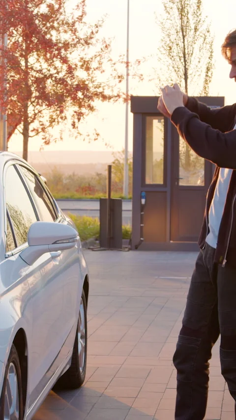 Customer examining two cars before a test drive, capturing details with a Stock Footage 319944932