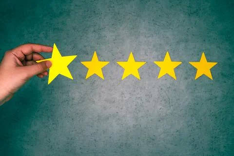 Customer Experience Concept. Hand holding five star excellent rating. Stock Photos