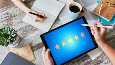 Customer experience satisfaction, feedback, review. Stars icon on device screen. Stock-Fotos