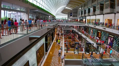 Customer flow inside of big shopping mall The Shoppes at Marina Bay Sands Stock Footage 57705399