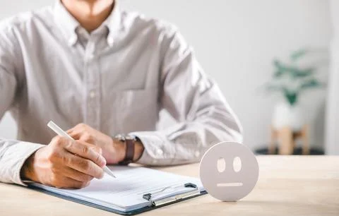 Customer gives feedback on service, completing satisfaction survey form wit.. Stock Photos