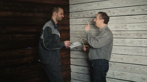 The customer gives instructions to the Builder Stock Footage 88864313