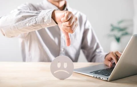 Customer gives thumbs down expressing negative feedback, showing dissatisfa.. Stock Photos