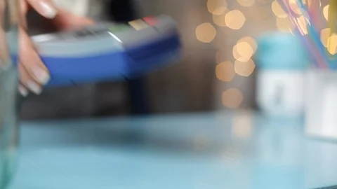 Customer hand pays with smartphone in store using NFC technology. Mobile phone  Stock Footage 120572022