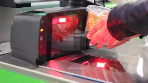 Customer hand scanning barcode of food under price scanner machine installed on Stock Footage 136934393