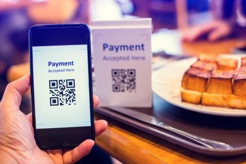 Customer hand using smart phone to scan QR code tag with blur  bread set meal Stock Photos
