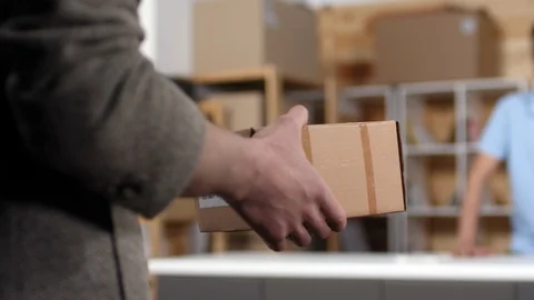 Customer Handing in Parcel for Shipping at Post Office Stock Footage 114212519