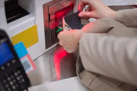Customer hands scanning product data using a modern barcode reader at a sel.. Stock Photos
