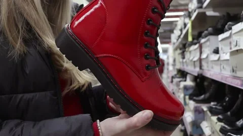 Customer holding red shoes when buying in shop Video stock 236858415